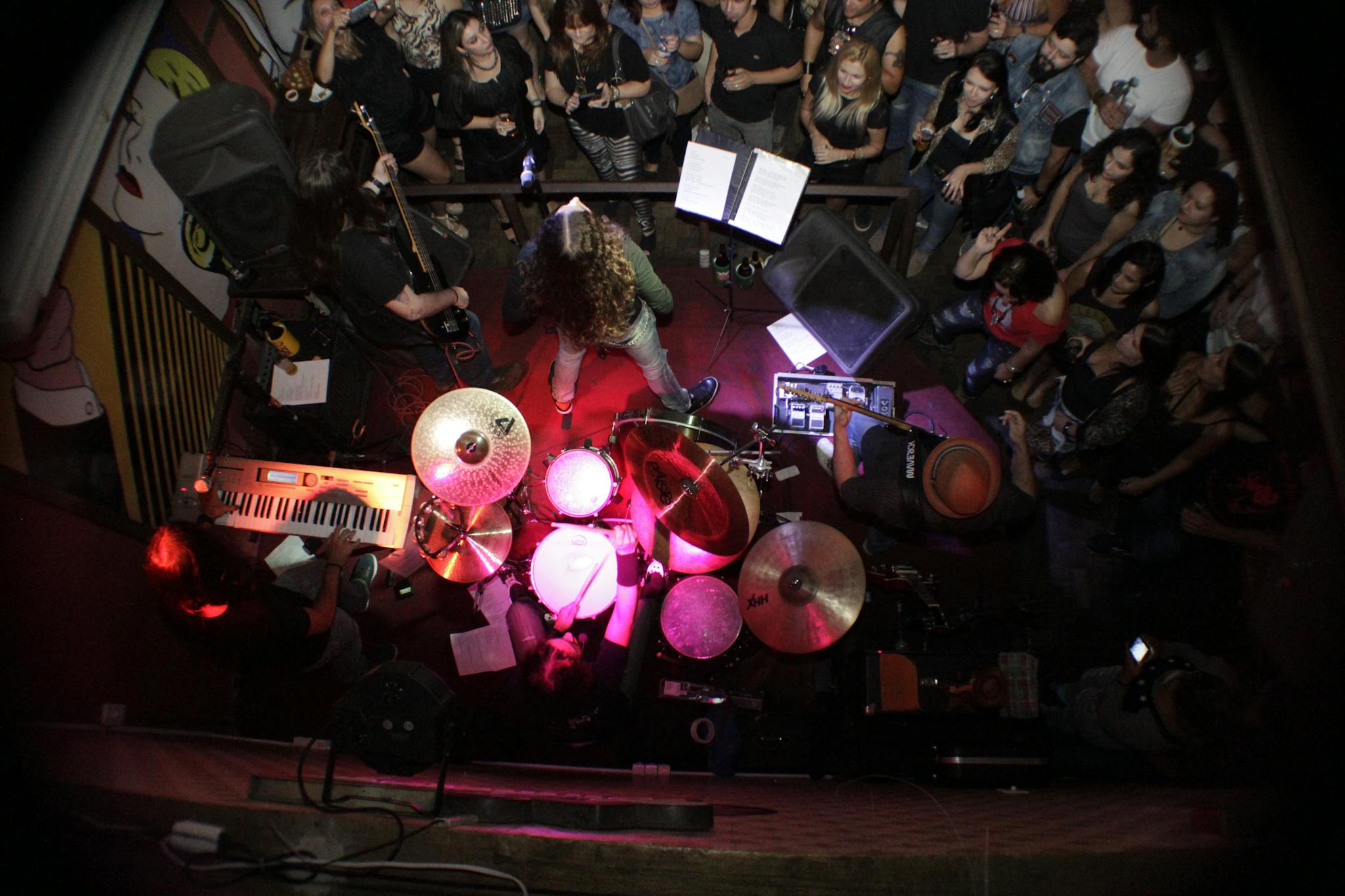 Energetic live band performance with audience enjoying music from top view.